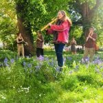 Belen Prado from Enchanted Flute teaching at a workshop in a park